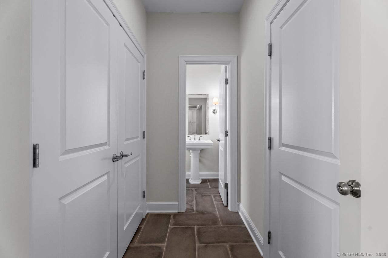 67 Boston Post Road, Unit 8 Madison, CT 06443 - Photo 16 of 35 First floor hall; utility closet to the left, garage entry to the right