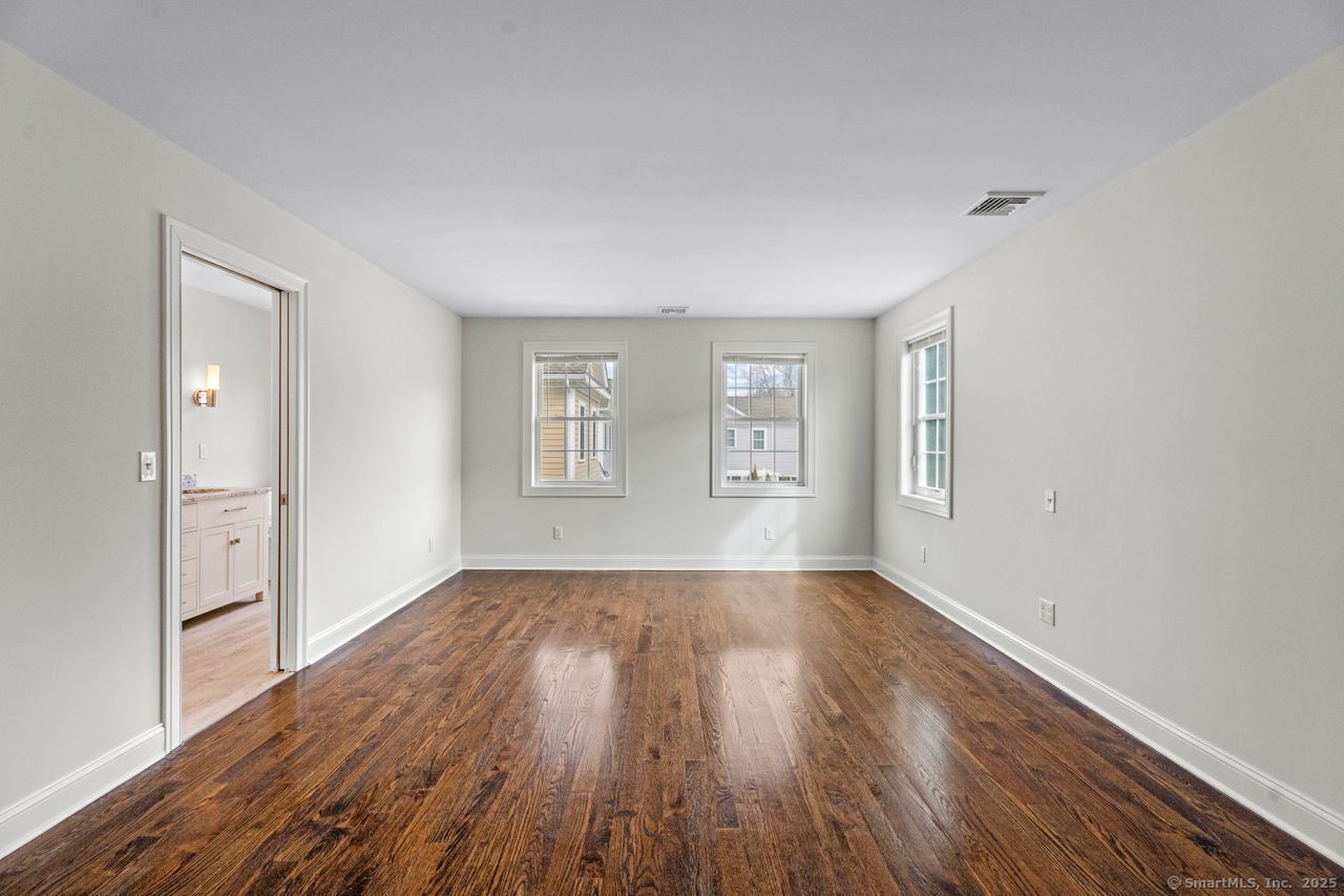67 Boston Post Road, Unit 8 Madison, CT 06443 - Photo 20 of 35 Generous primary bedroom with ensuite bathroom and beautiful hardwood floors
