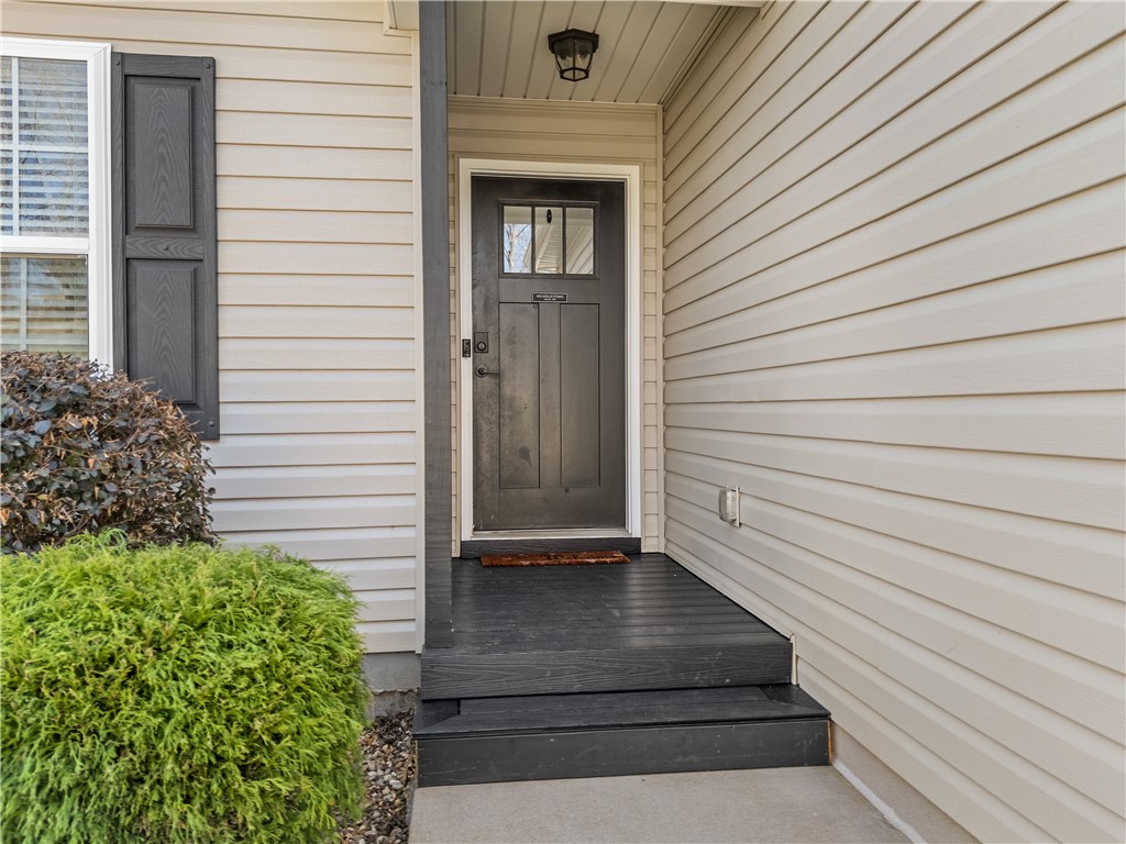 2520 Linmar Circle Anderson, SC 29621 - Photo 6 of 50 A welcoming entry with a dark-paneled door and classic light-colored siding, accented by vibrant shrubbery.