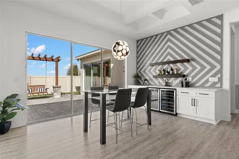 a view of a livingroom with furniture wooden floor and a chandelier