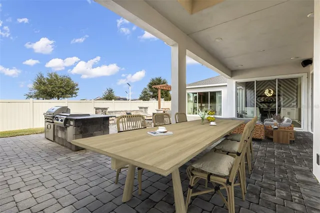 a kitchen that has a lot of cabinets a sink and appliances in it