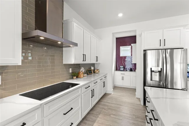 a open kitchen with stainless steel appliances granite countertop a sink and white cabinets