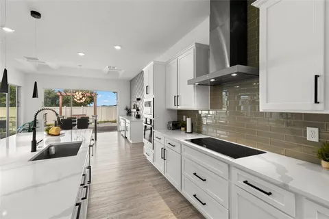 a spacious bedroom with a bed and a potted plant