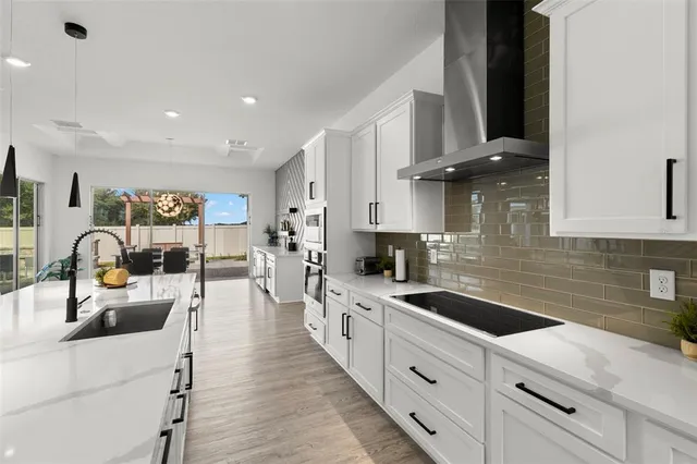 a spacious bedroom with a bed and a potted plant