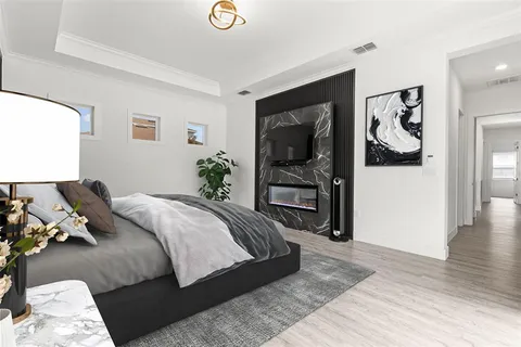 a bedroom with a bed and a television