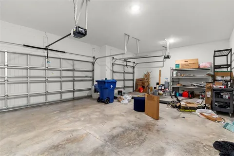 a view of living room kitchen with stainless steel appliances dining table and chairs