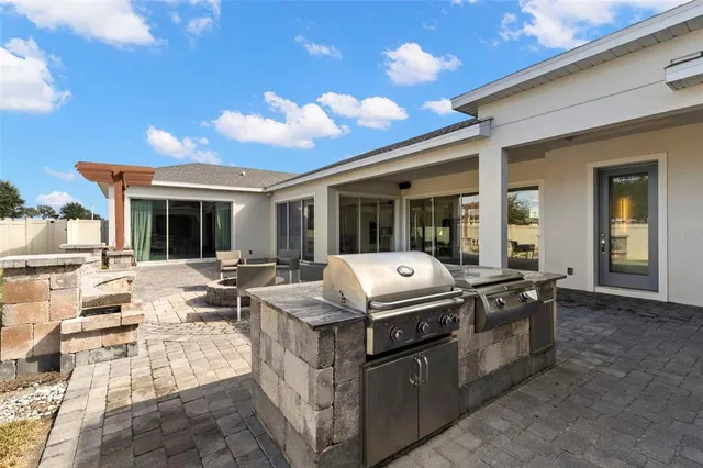 a view of a patio with table and chairs