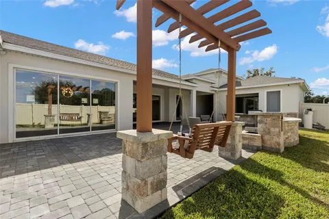 a view of a patio with dining table and chairs with wooden floor