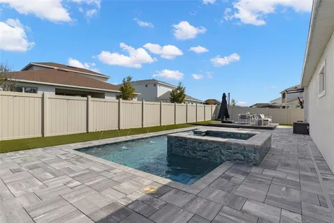 a view of a house with swimming pool and sitting area