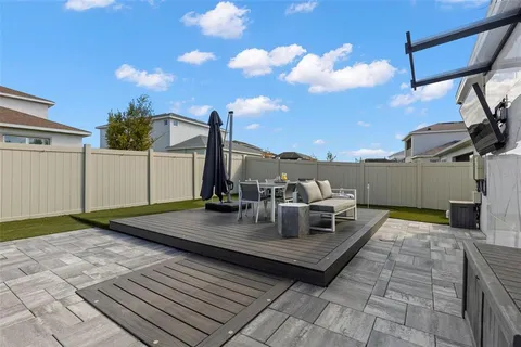 a view of a patio with table and chairs under an umbrella