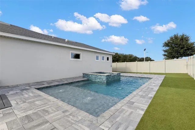 a view of a swimming pool and trees in the background