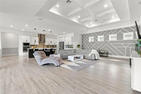a living room with furniture and a chandelier