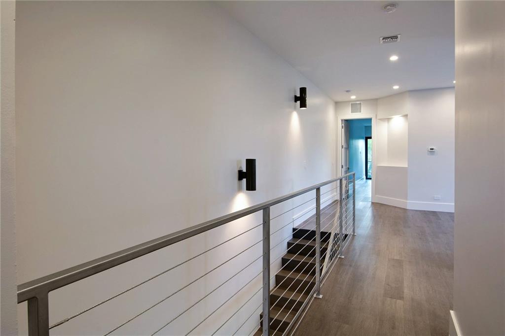317 Northeast 15th Avenue, Unit 317 Fort Lauderdale, FL 33301 - Photo 16 of 26 a hallway with wooden floor and staircase