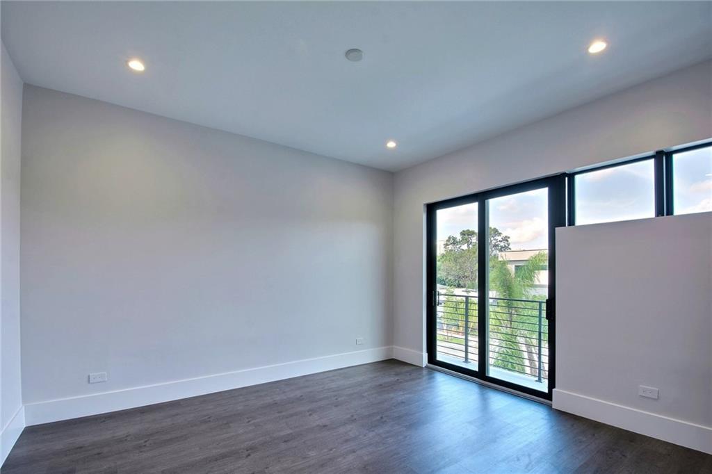 317 Northeast 15th Avenue, Unit 317 Fort Lauderdale, FL 33301 - Photo 19 of 26 a view of an empty room with wooden floor and a window