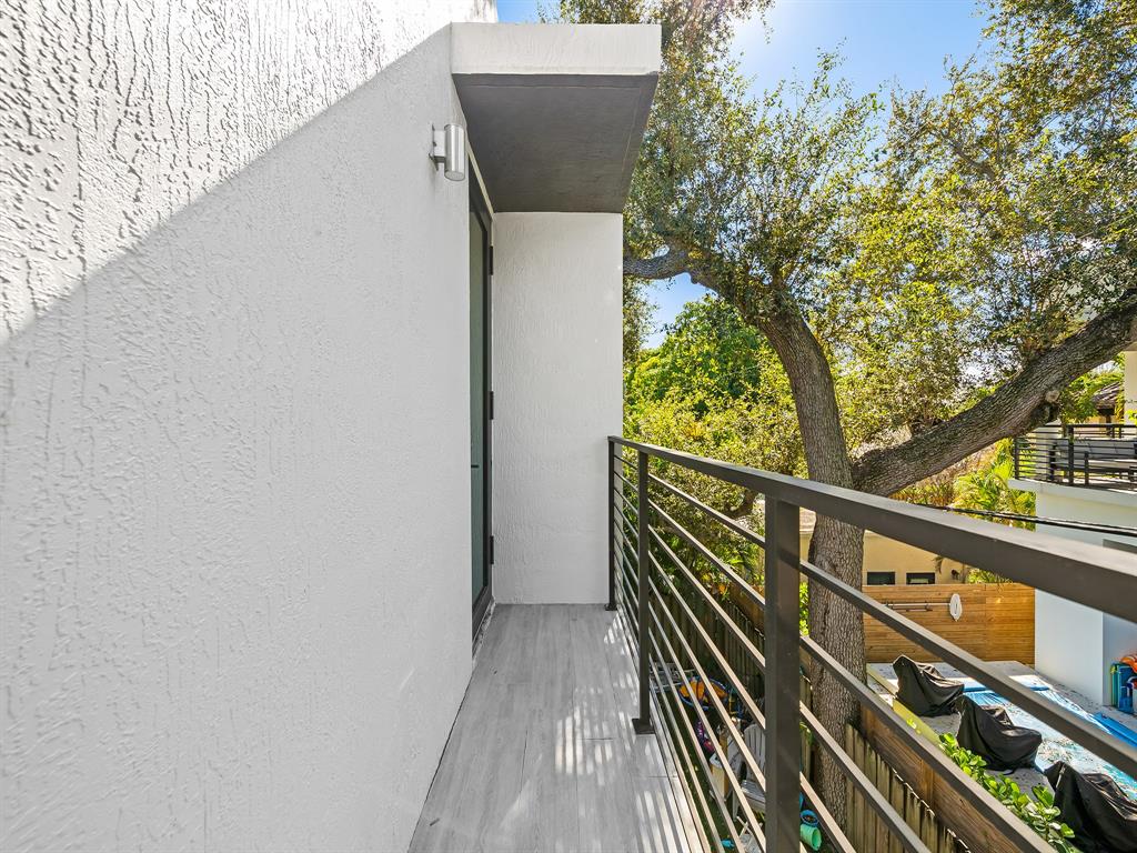 317 Northeast 15th Avenue, Unit 317 Fort Lauderdale, FL 33301 - Photo 20 of 26 a view of balcony with wooden floor and fence