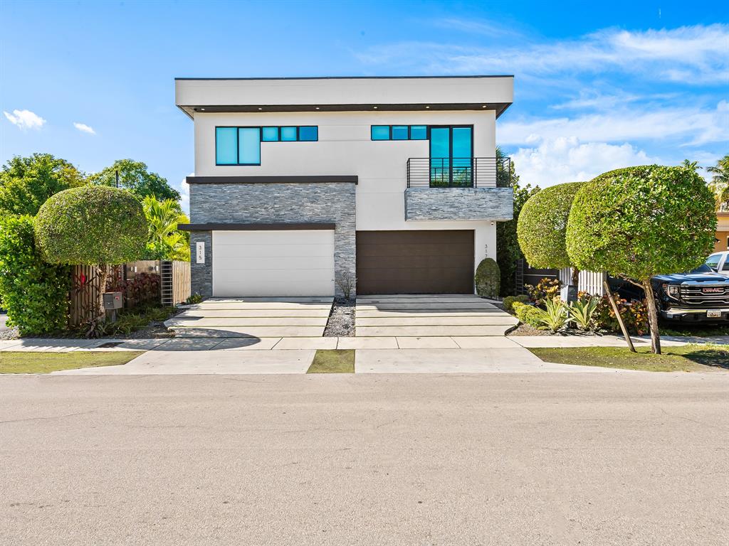 317 Northeast 15th Avenue, Unit 317 Fort Lauderdale, FL 33301 - Photo 24 of 26 a front view of a house with garden