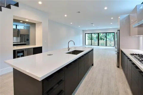 a kitchen with a stove a sink and a refrigerator