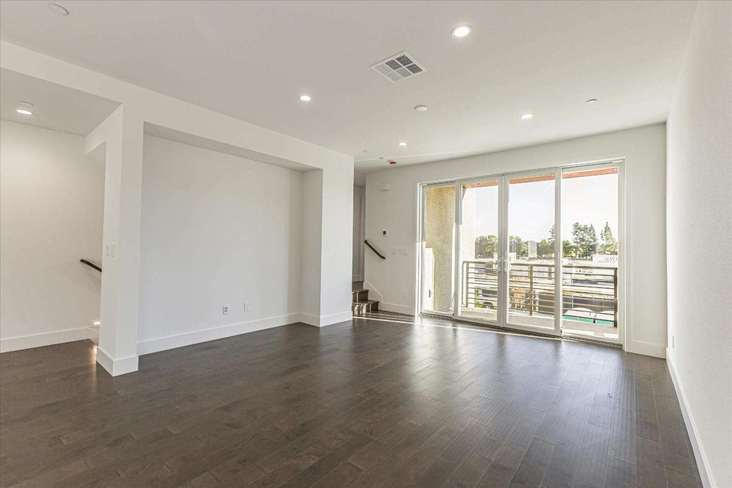 6008 Sunglow Terrace San Ramon, CA 94583 - Photo 4 of 23 an empty room with wooden floor and sliding glass door