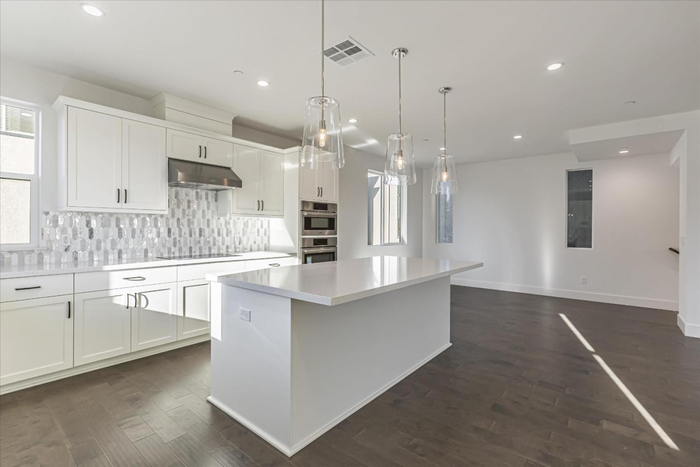 6008 Sunglow Terrace San Ramon, CA 94583 - Photo 6 of 23 a large kitchen with granite countertop a white stove top oven a sink dishwasher and a refrigerator with wooden floor