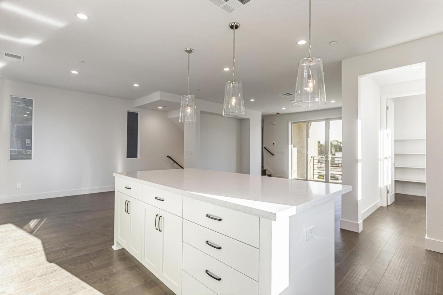 6008 Sunglow Terrace San Ramon, CA 94583 - Photo 7 of 23 a kitchen with a sink chandelier and wooden floor