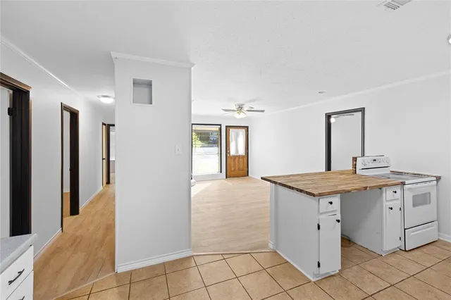 a kitchen with granite countertop a sink stove and cabinets