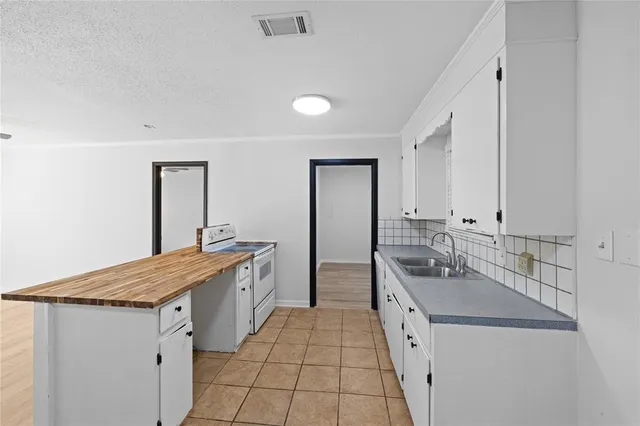 a kitchen with white cabinets and white appliances