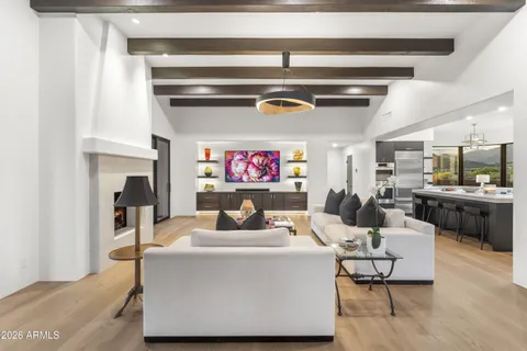 a living room with furniture large window and fireplace