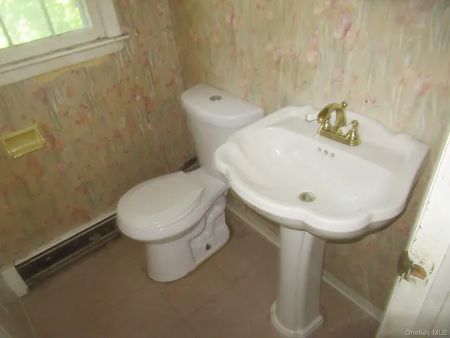 a kitchen with cabinets appliances a sink and a window