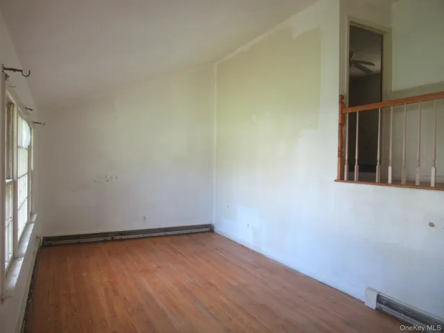 an empty room that has a grey walls