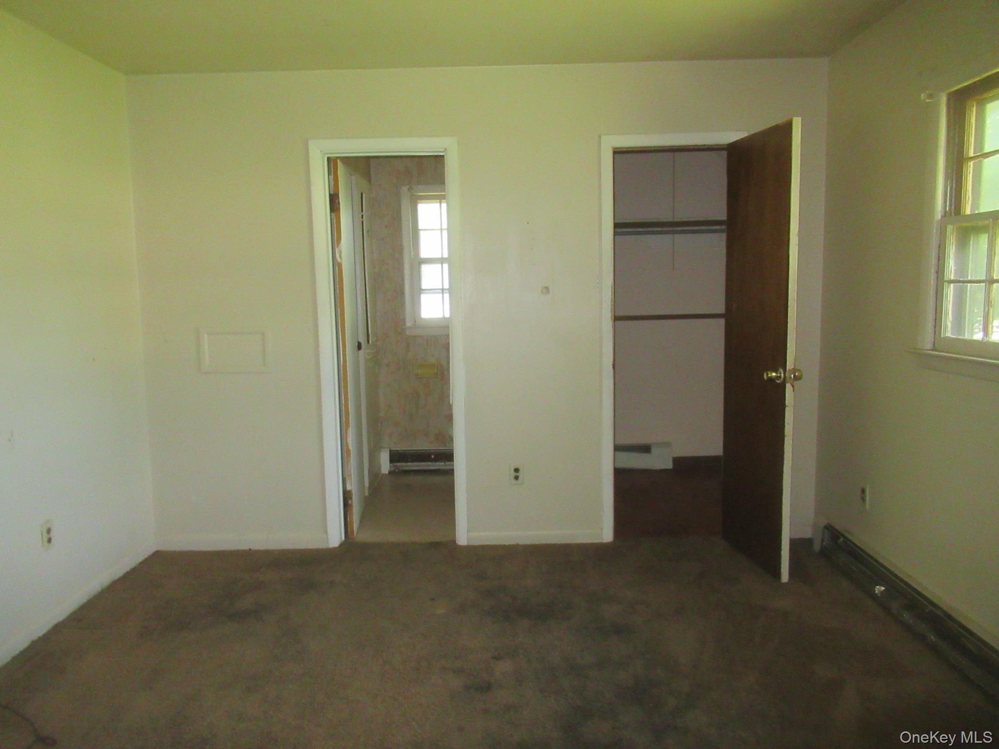 24 Edinburgh Road Middletown, NY 10941 - Photo 6 of 17 Unfurnished bedroom with multiple windows, carpet flooring, a walk in closet, and a closet
