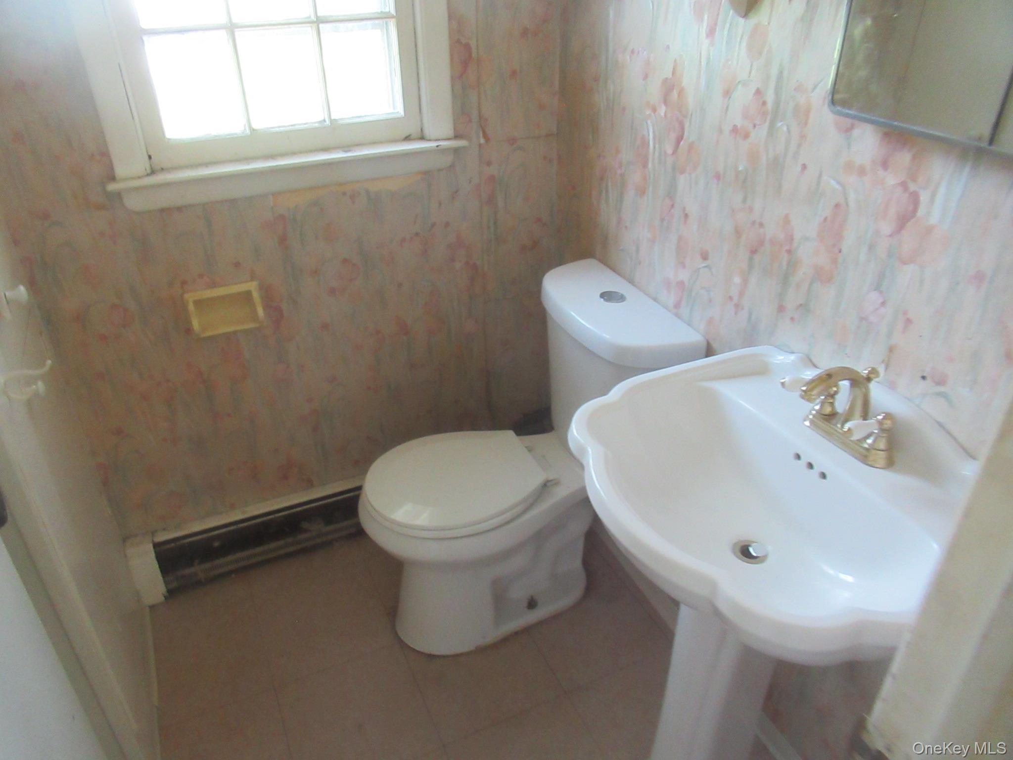 24 Edinburgh Road Middletown, NY 10941 - Photo 7 of 17 Half bathroom featuring a baseboard heating unit, tile patterned flooring, and wallpapered walls