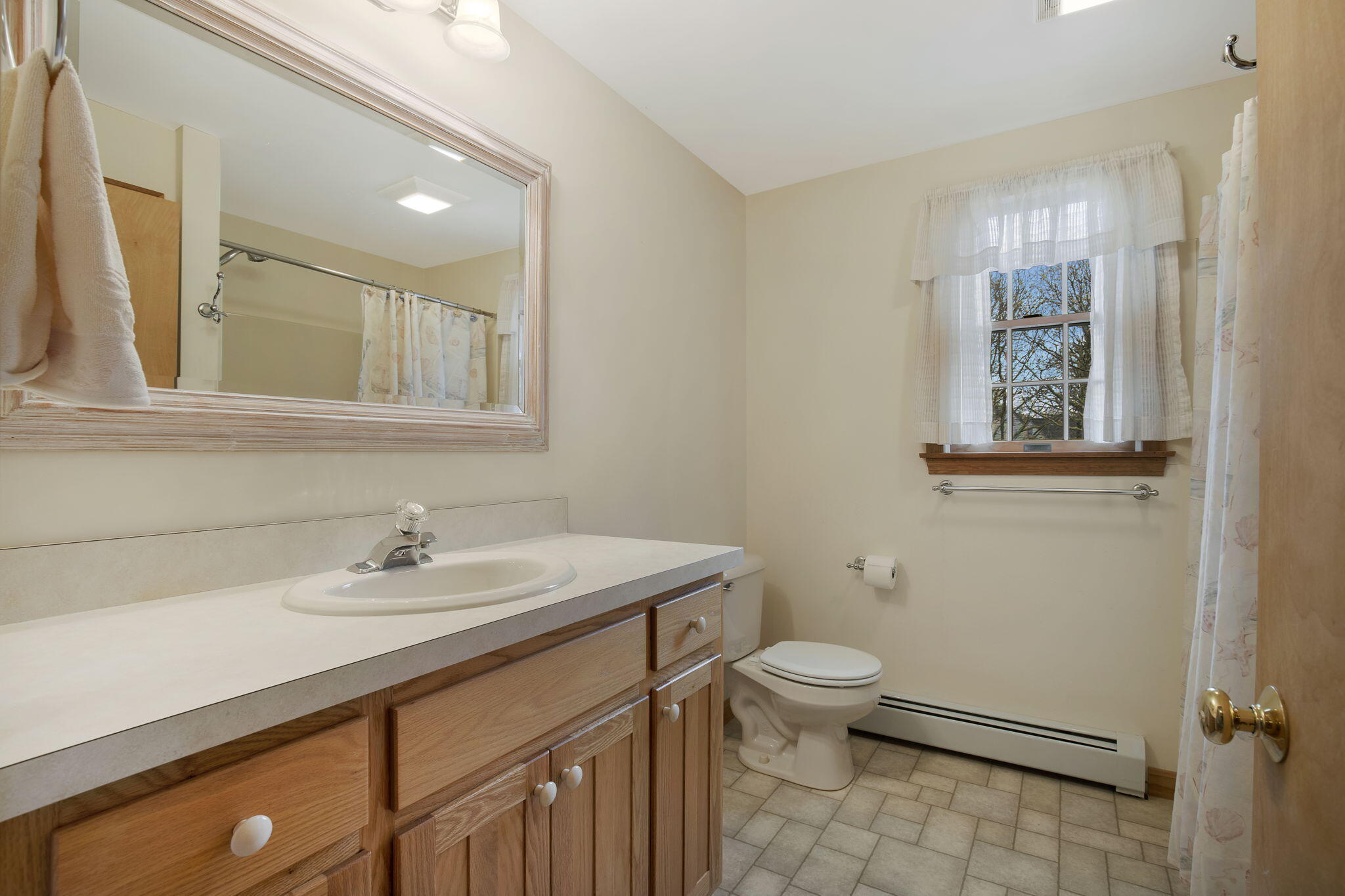 65 Whitney Road Eastham, MA 02642 - Photo 33 of 41 a bathroom with a sink a toilet and mirror