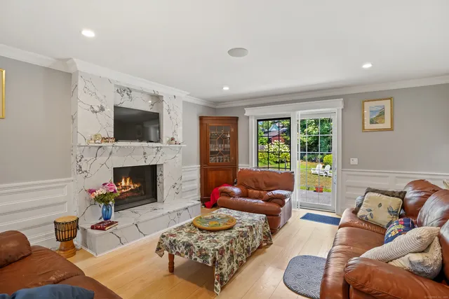 a living room with furniture fireplace and a flat screen tv