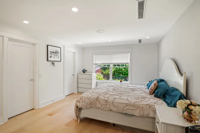 a bedroom with a bed and a large window