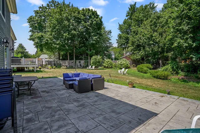 a view of a backyard with sitting area