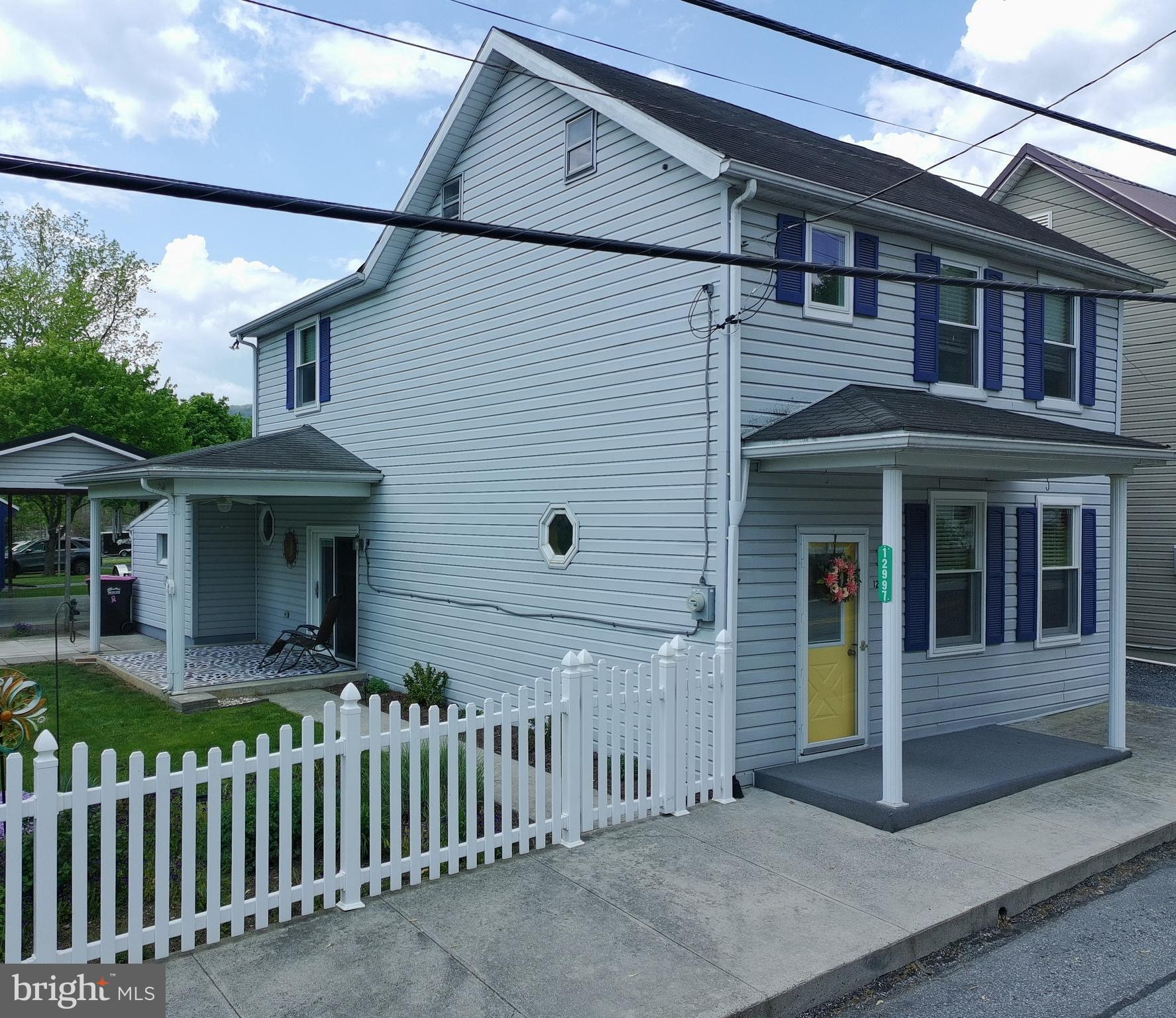 12997 Main Street Fort Loudon, PA 17224 - Photo 2 of 48 a front view of a house with a garden