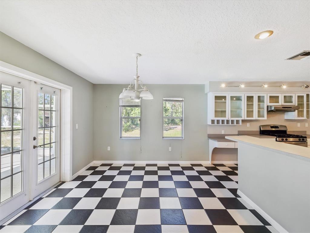 15420 Aubrey Avenue Spring Hill, FL 34610 - Photo 10 of 28 a black and white checkered floor with a black white checkered floor