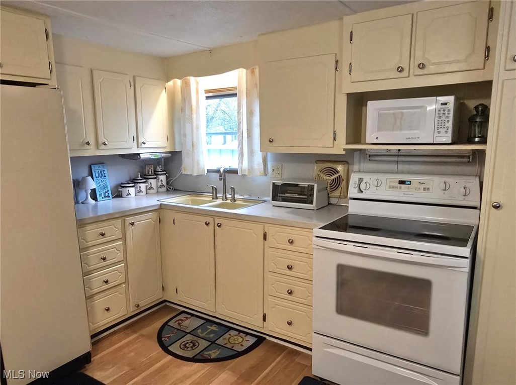 Kitchen with range, microwave and refrigerator
