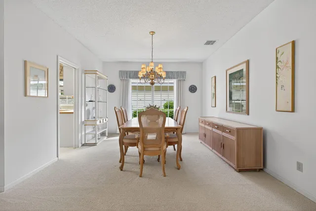 a living room with granite countertop furniture a fireplace and a chandelier