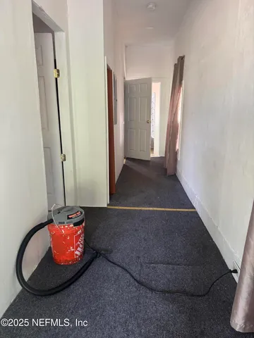 a view of an entryway with wooden floor