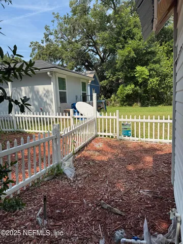 a view of a house with a small yard and plants