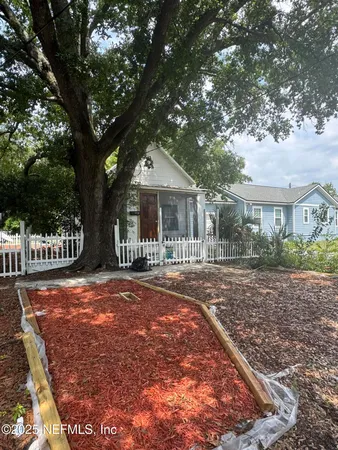 a front view of a house with a garden