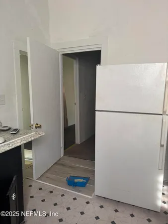 a refrigerator freezer and a wooden floor