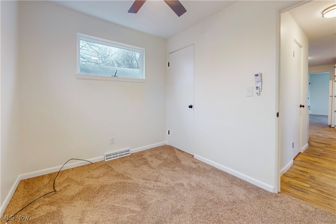 1723 Bantam Ridge Road Steubenville, OH 43953 - Photo 18 of 22 Empty room featuring light carpet, baseboards, visible vents, and ceiling fan