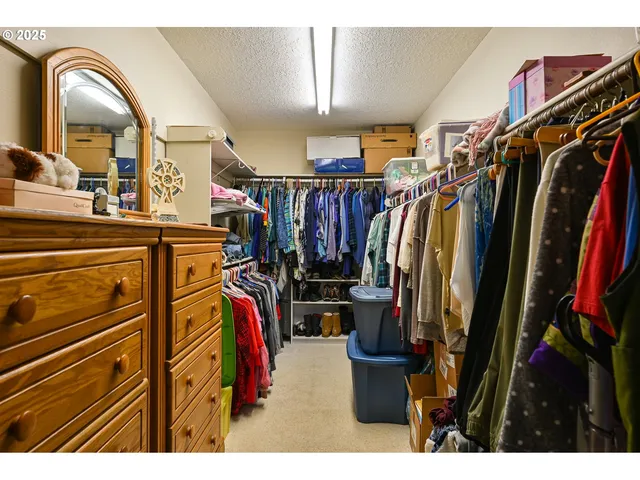 a view of walk in closet with clothes