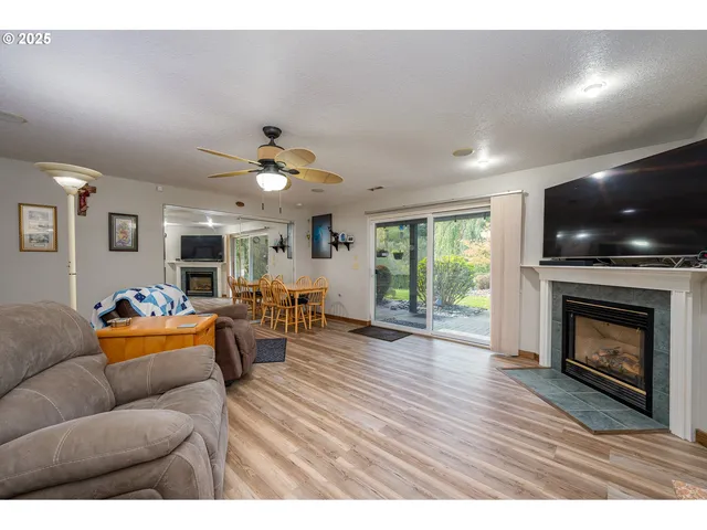 a living room with furniture a fireplace and a flat screen tv