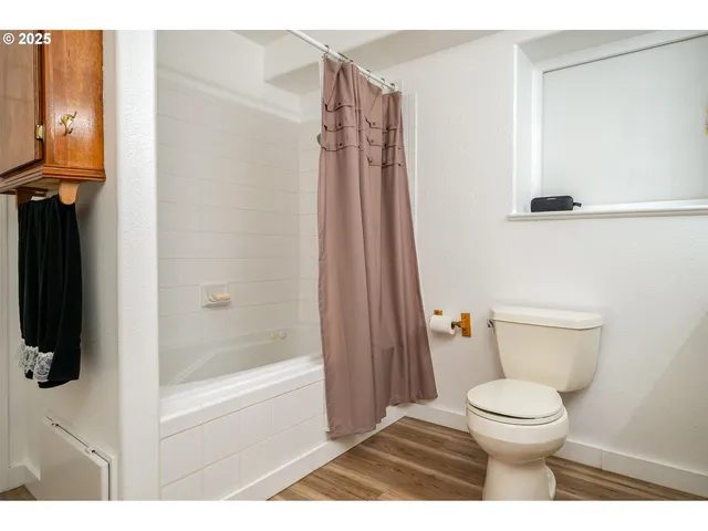 a bathroom with a toilet and a shower
