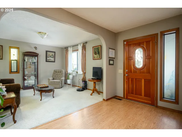 a living room with furniture and a wooden door
