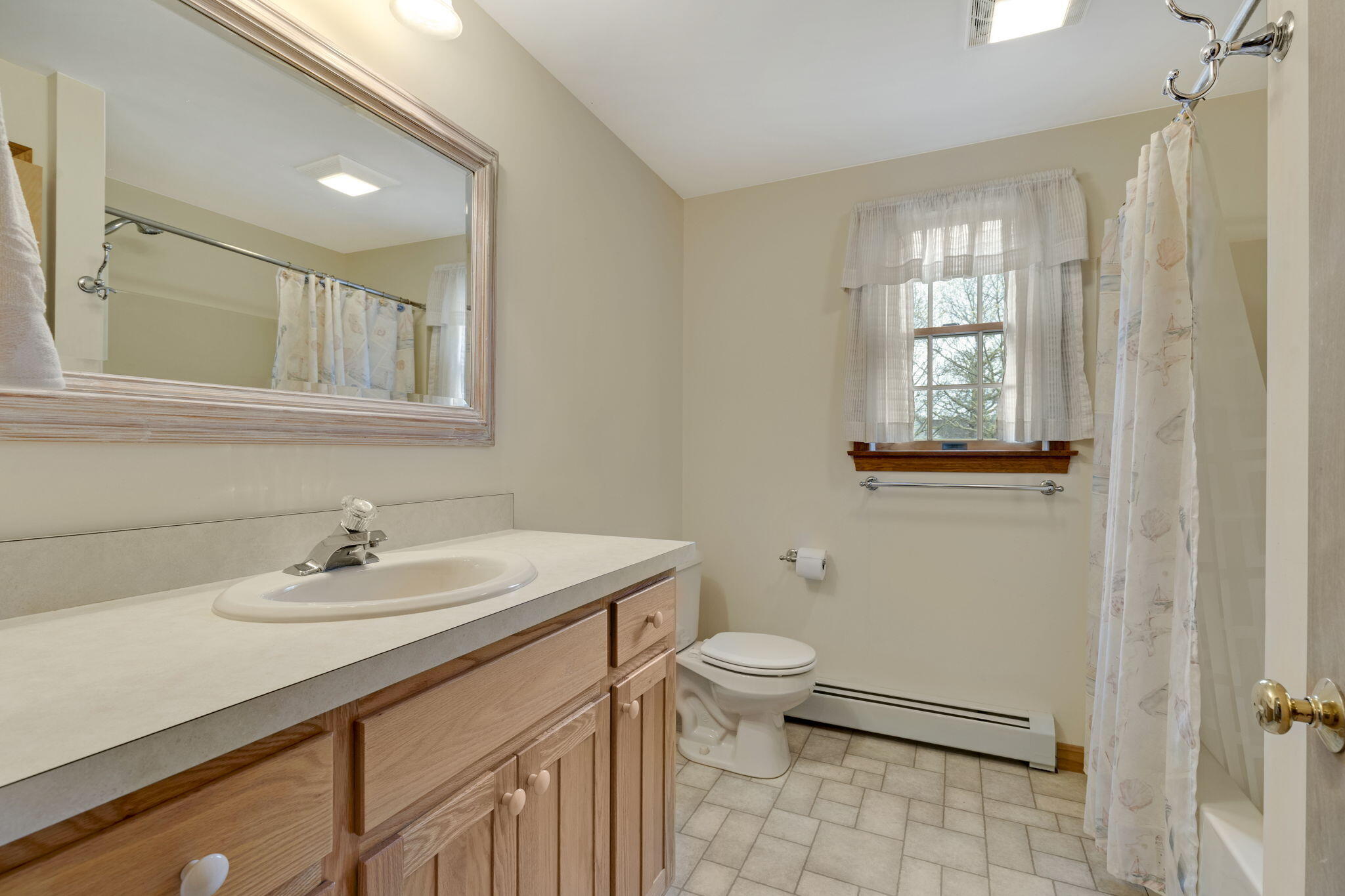 65 Whitney Road Eastham, MA 02642 - Photo 32 of 41 a bathroom with a sink toilet and window