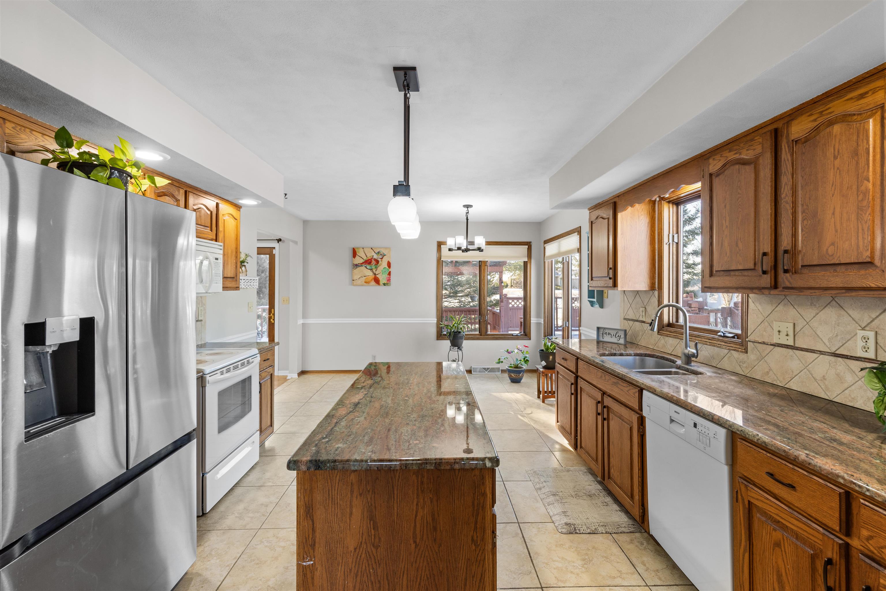 7467 McCurry Road Roscoe, IL 61073 - Photo 19 of 29 a kitchen with stainless steel appliances granite countertop a sink stove and refrigerator